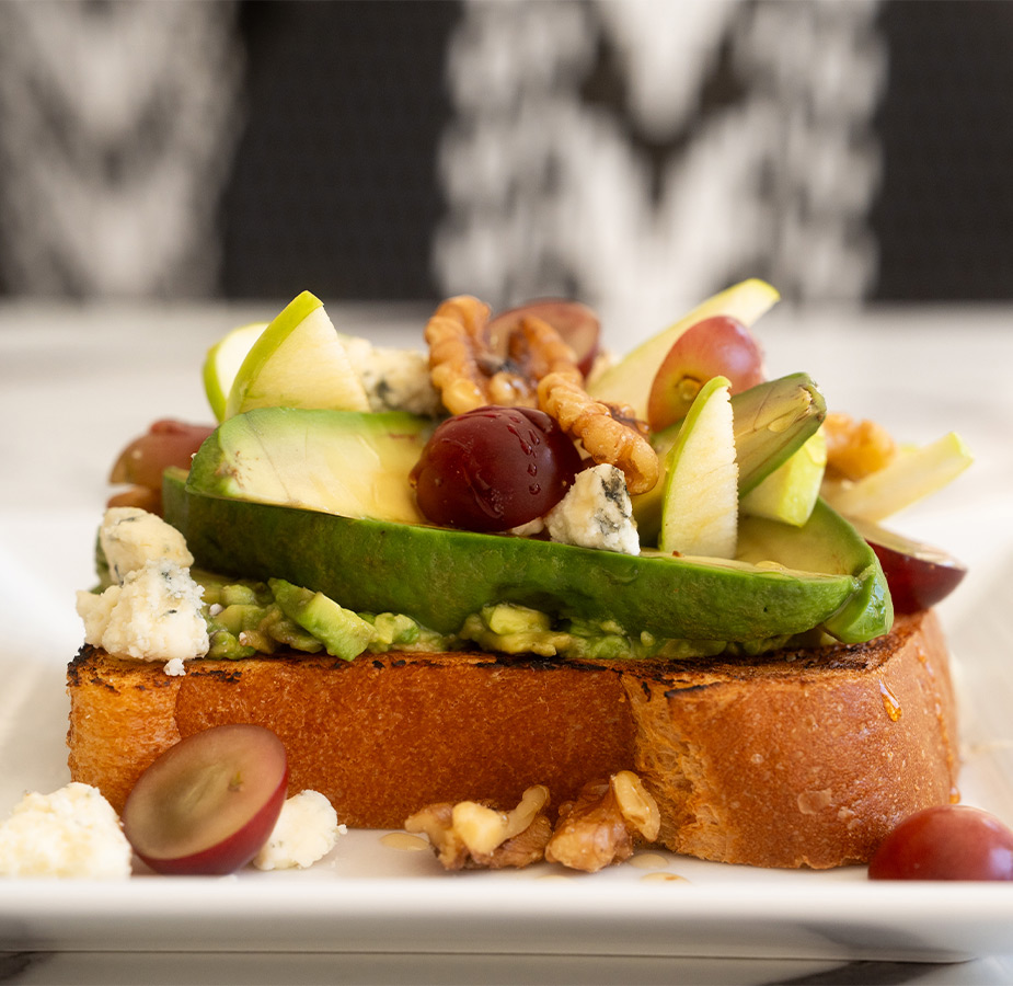 A plate with avocado toast on it.