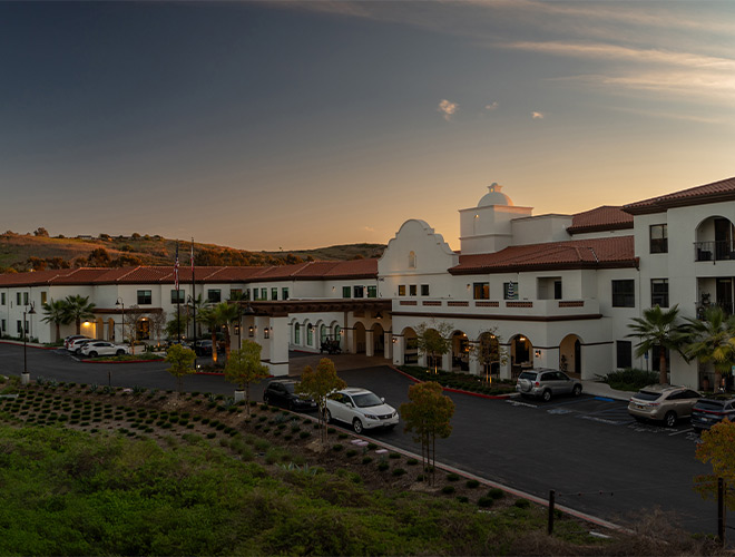 The exterior of the building at sunset.