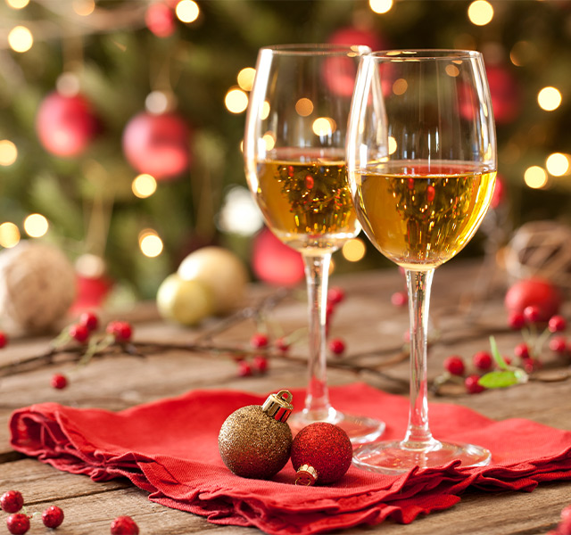 Two drinks on a table with holiday decor.