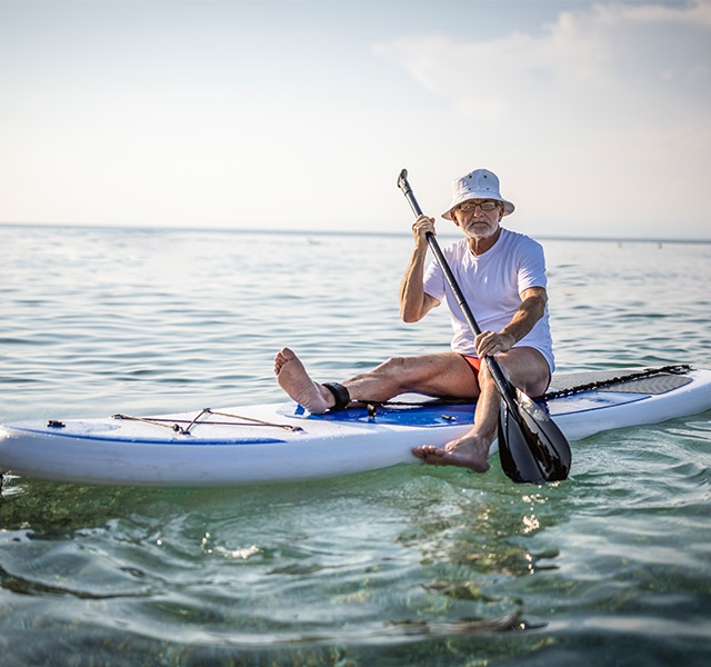 A person sitting on a paddleboard.
