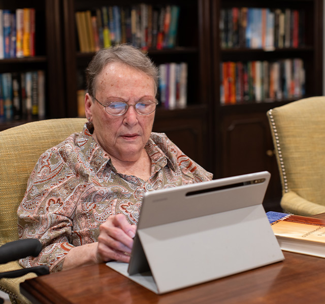 A person on the computer at the library.
