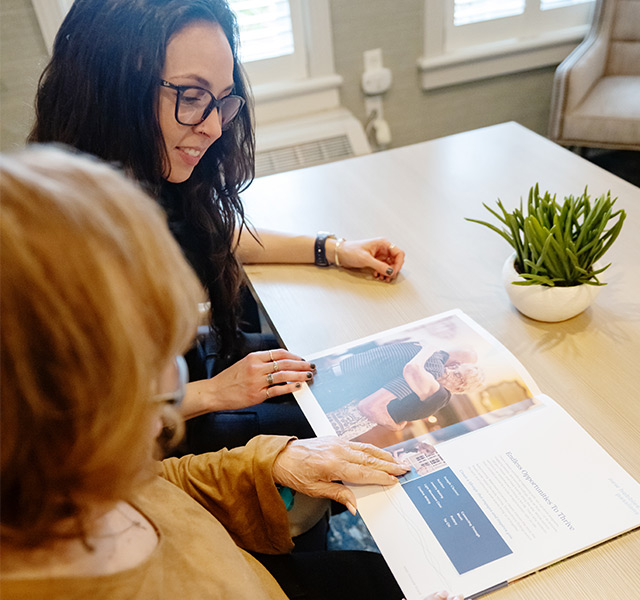 People looking at a brochure.