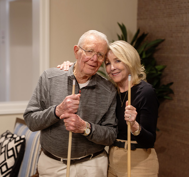 A father and daughter smiling.