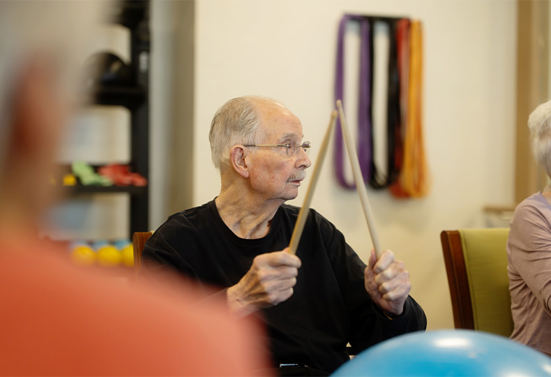 A person drumming on a ball.