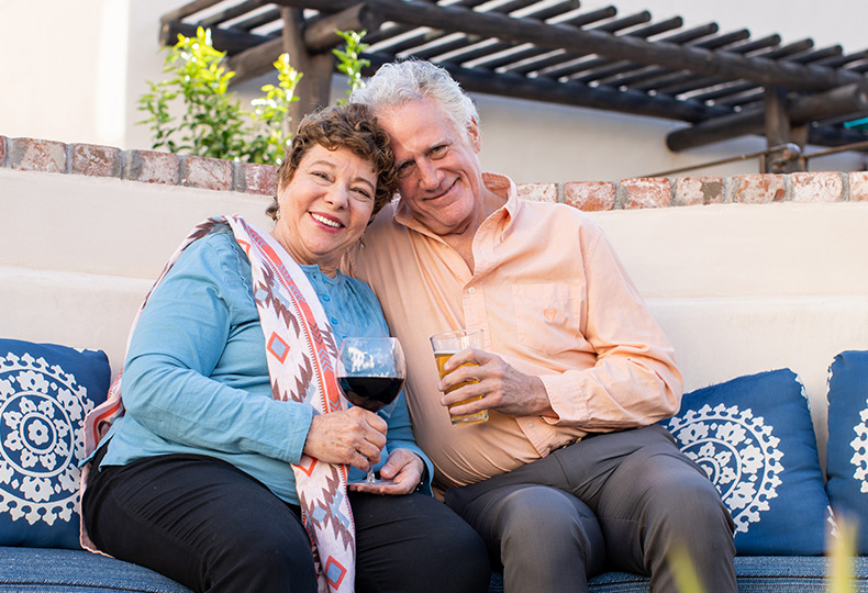 A couple sitting and drinking wine together.