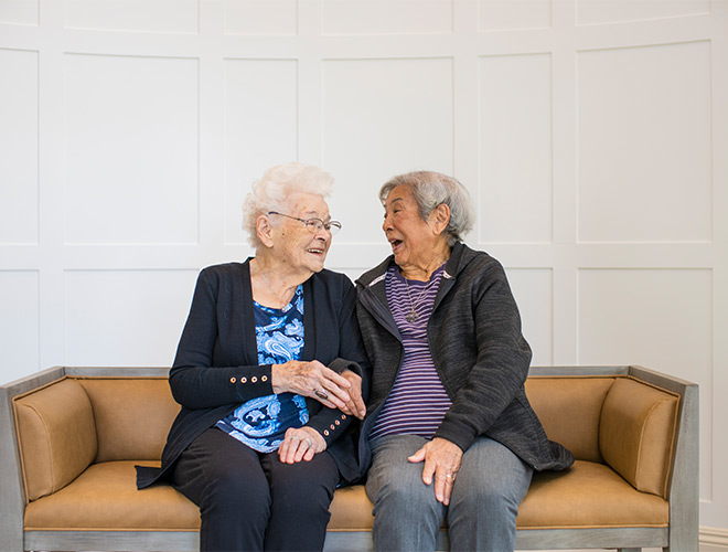 Two people sitting and laughing together.