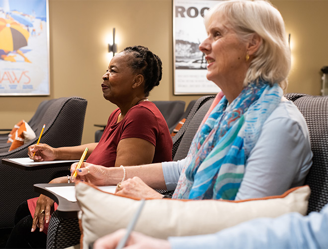 People taking notes in a class.