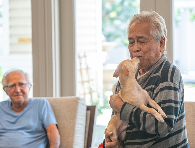 A person holding a dog.
