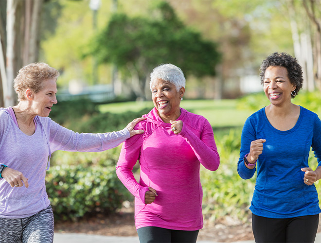 Three people walking outside.