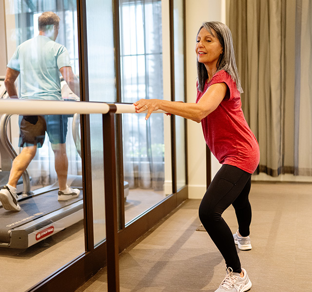 A person stretching in the gym.