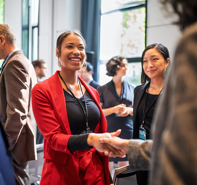 Young professionals greeting each other.