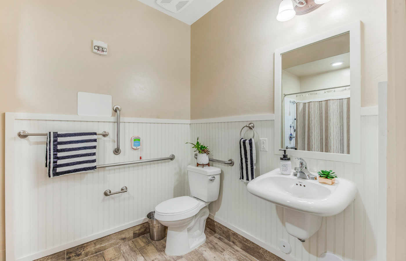 Bathroom with shower, toilet, and sink.