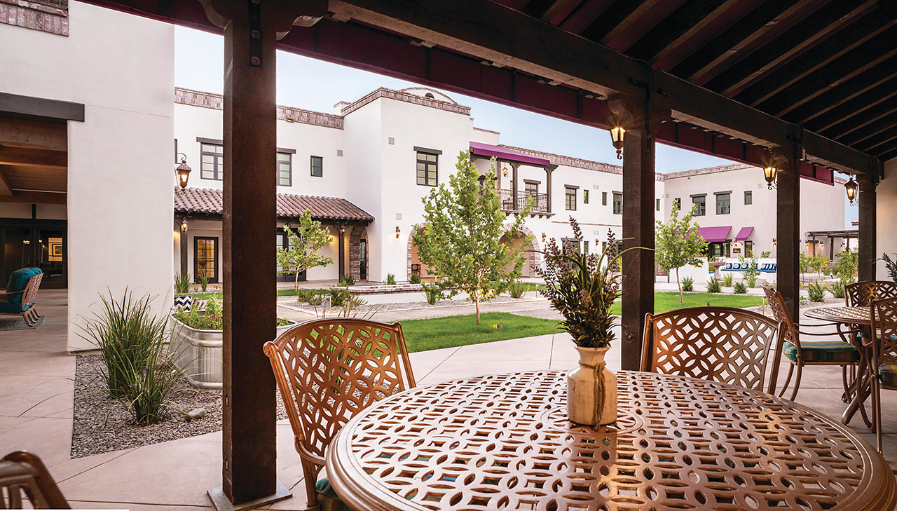 The Hacienda at the River exterior building and courtyard. 
