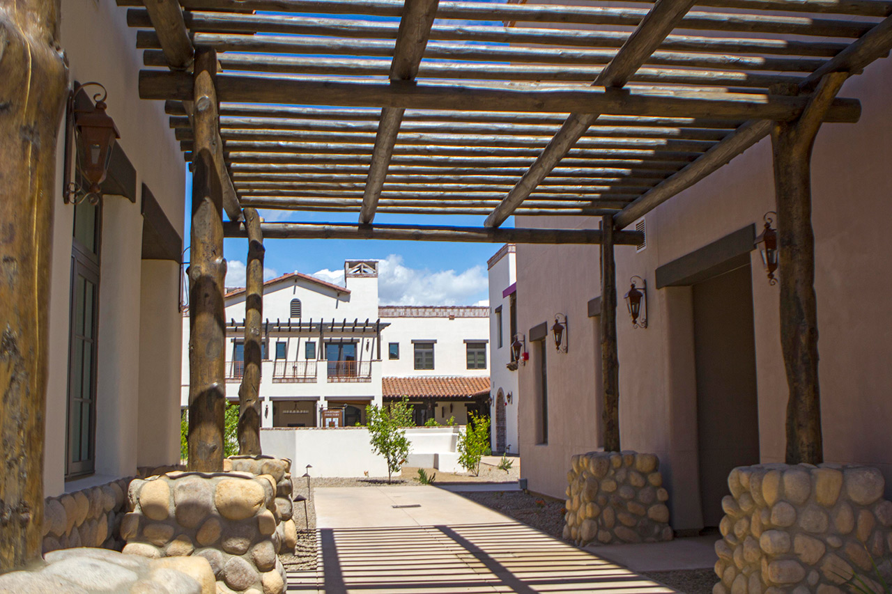 The Hacienda at the River exterior building and courtyard. 

