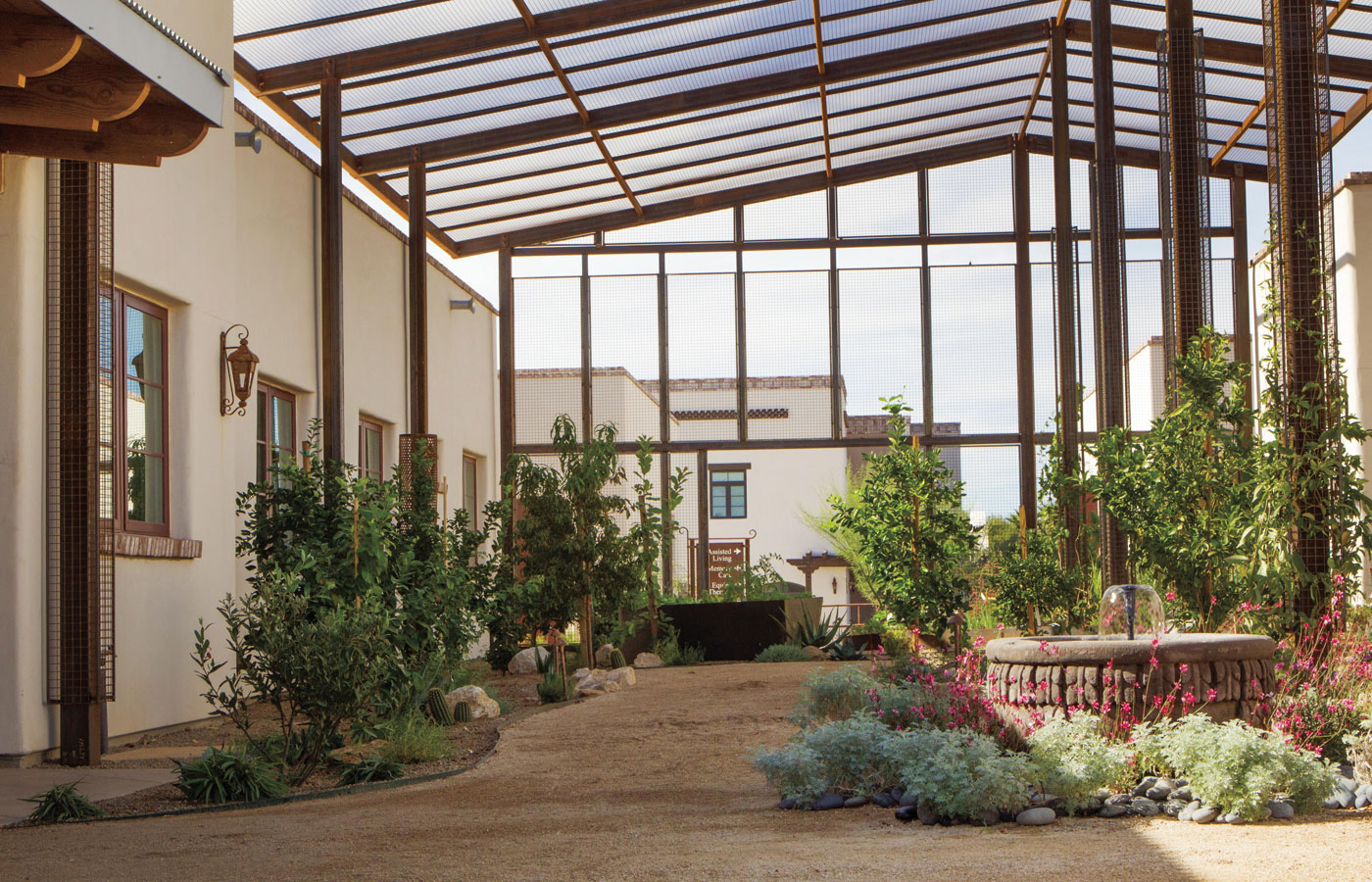The Hacienda at the River exterior building and courtyard and greenhouse.