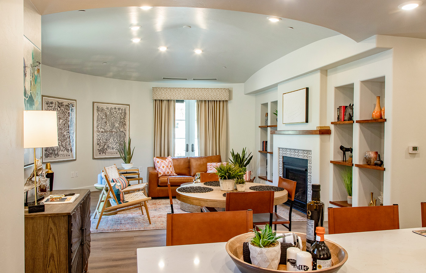 Furnished living room space with sofa, table, and seating area.
