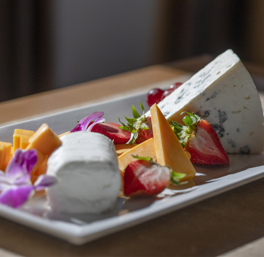 A cheese and fruit plate prepared by the an on-site chef.