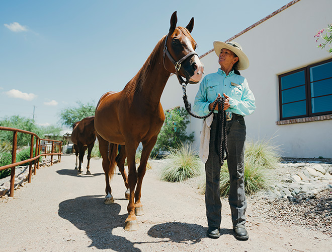A resident and a horse at the stables at The Hacienda at the River.