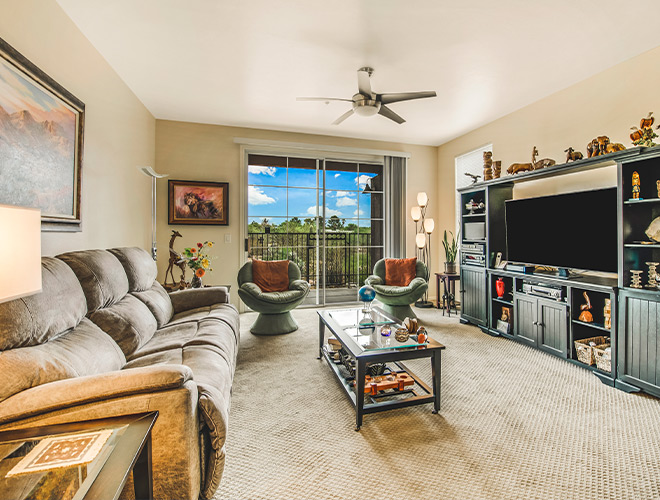 Furnished living room space with sofa, table, and seating area.
