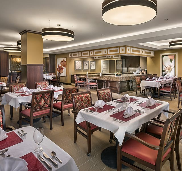 A dining room with tables set for service.