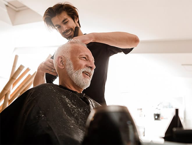 resident is having a haircut at the salon