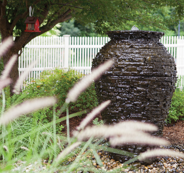 close up of large dark vase in garden outside