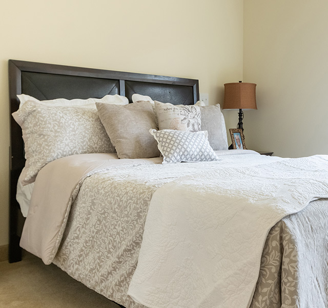 close up of made bed in bedroom