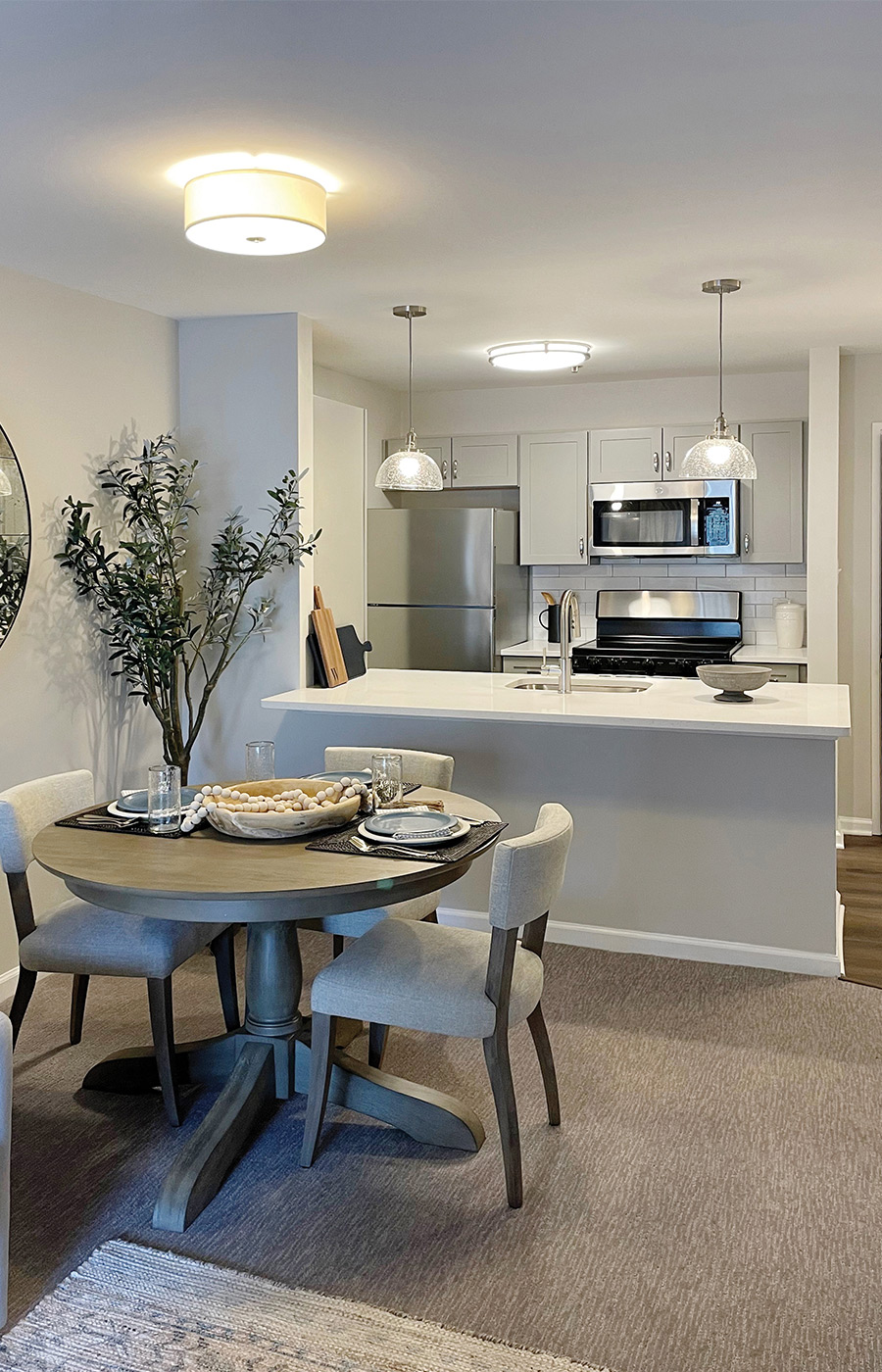 A fully furnished dining room and kitchen.