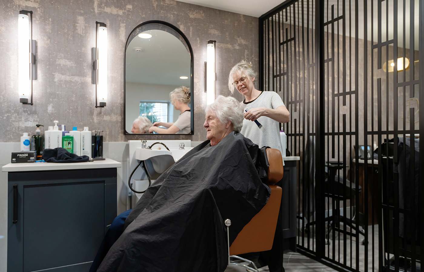 A person getting their hair styled.