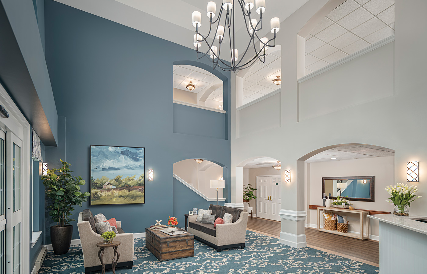 A beautiful lobby with stairs and a chandelier. 