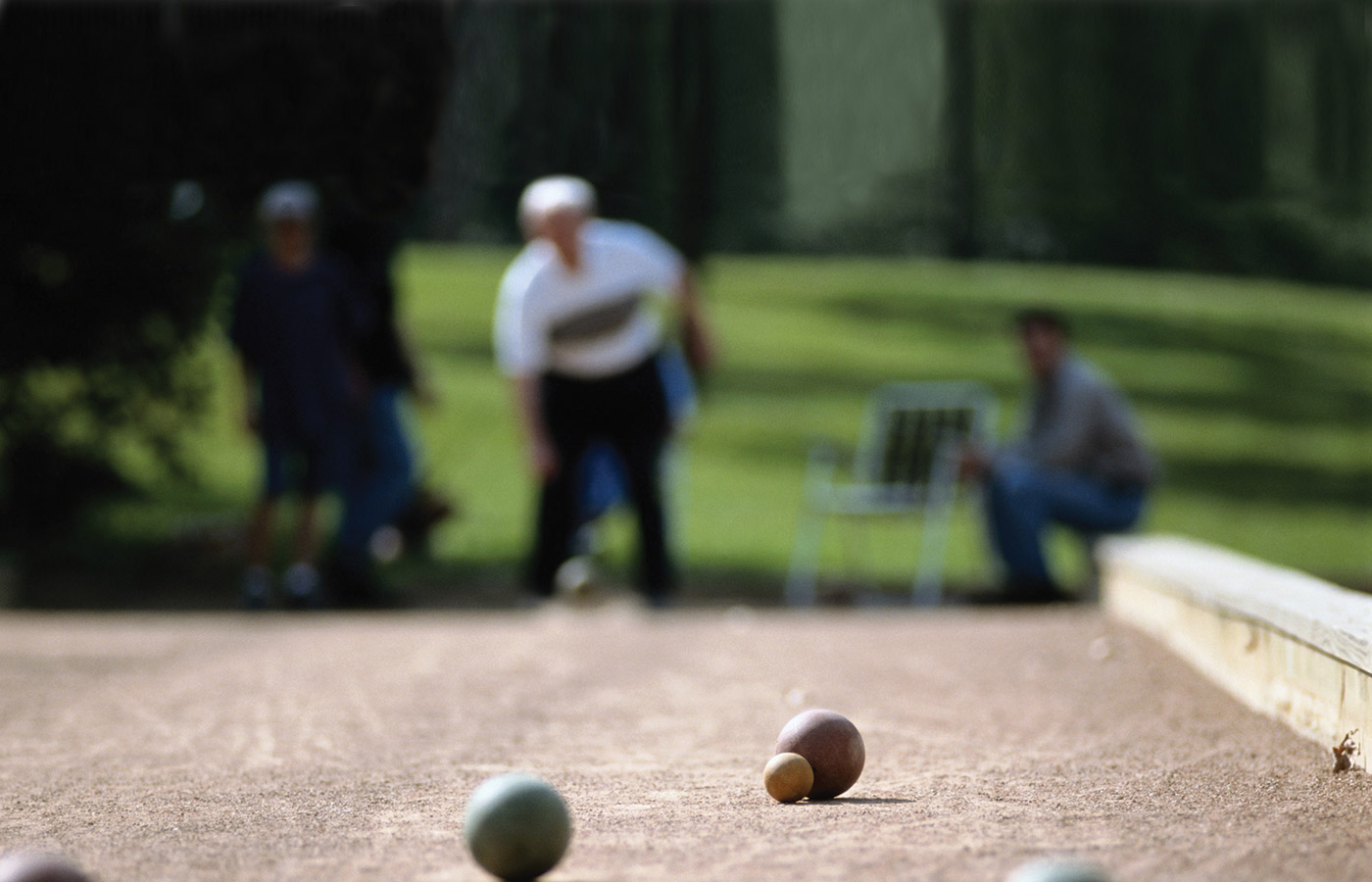 A resident is playing bocce ball.