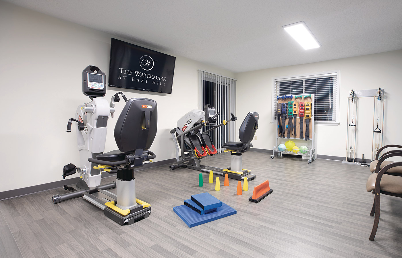 fitness room with various machines and weights