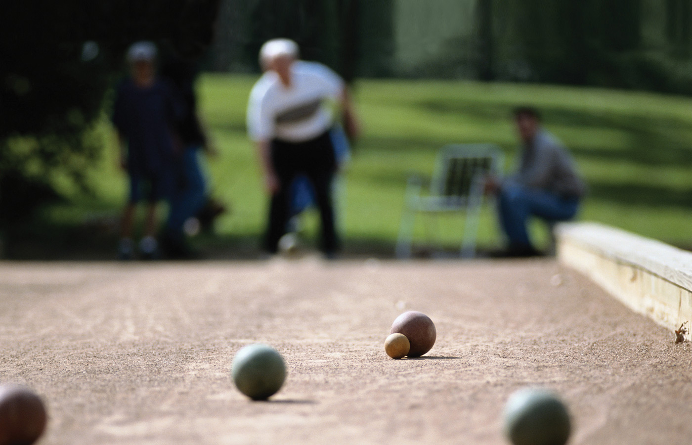 A resident is playing bocce ball.