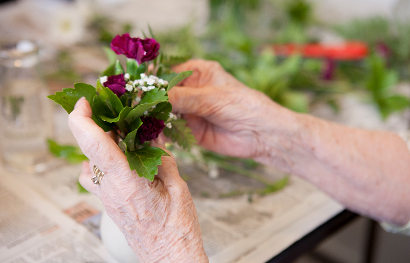A resident is arranging flowers.