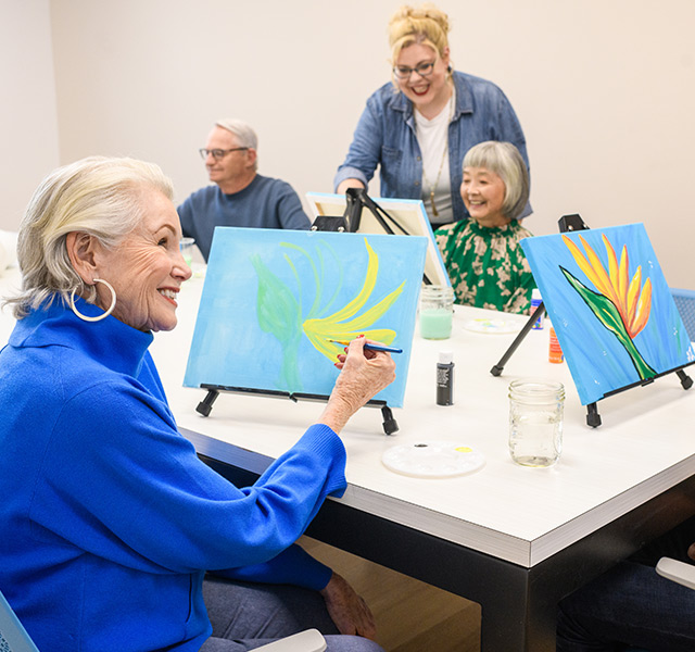 People painting in a class.