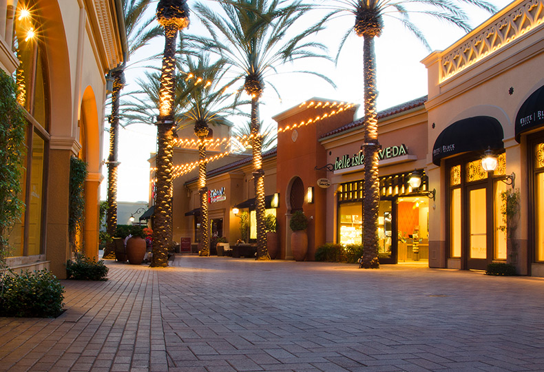 An outdoor mall with store fronts.