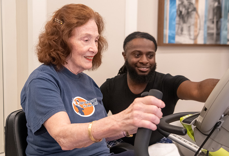 A person working out with a trainer.