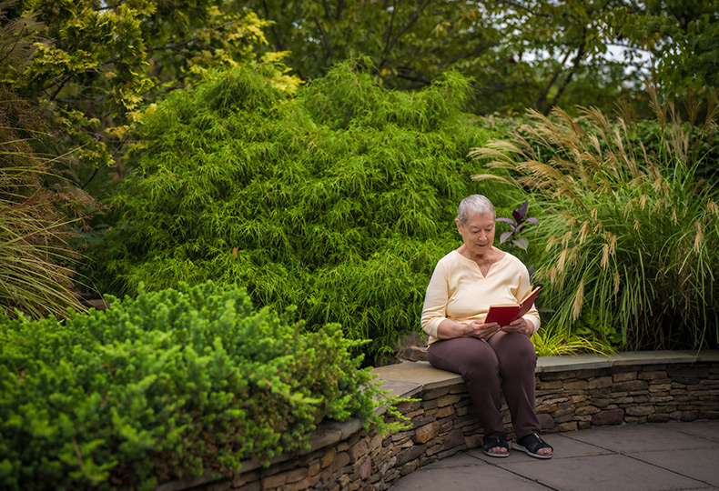 A person sitting outside reading a book.