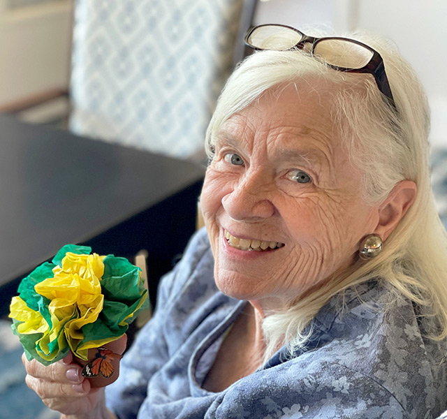 A person holding a paper flower.