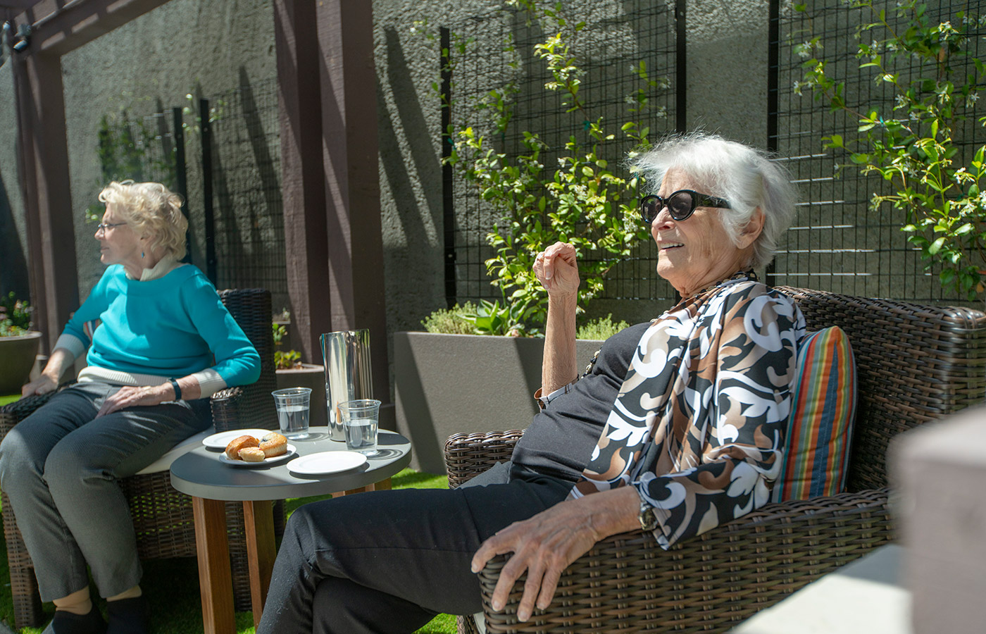 Residents are sitting outside in the courtyard.