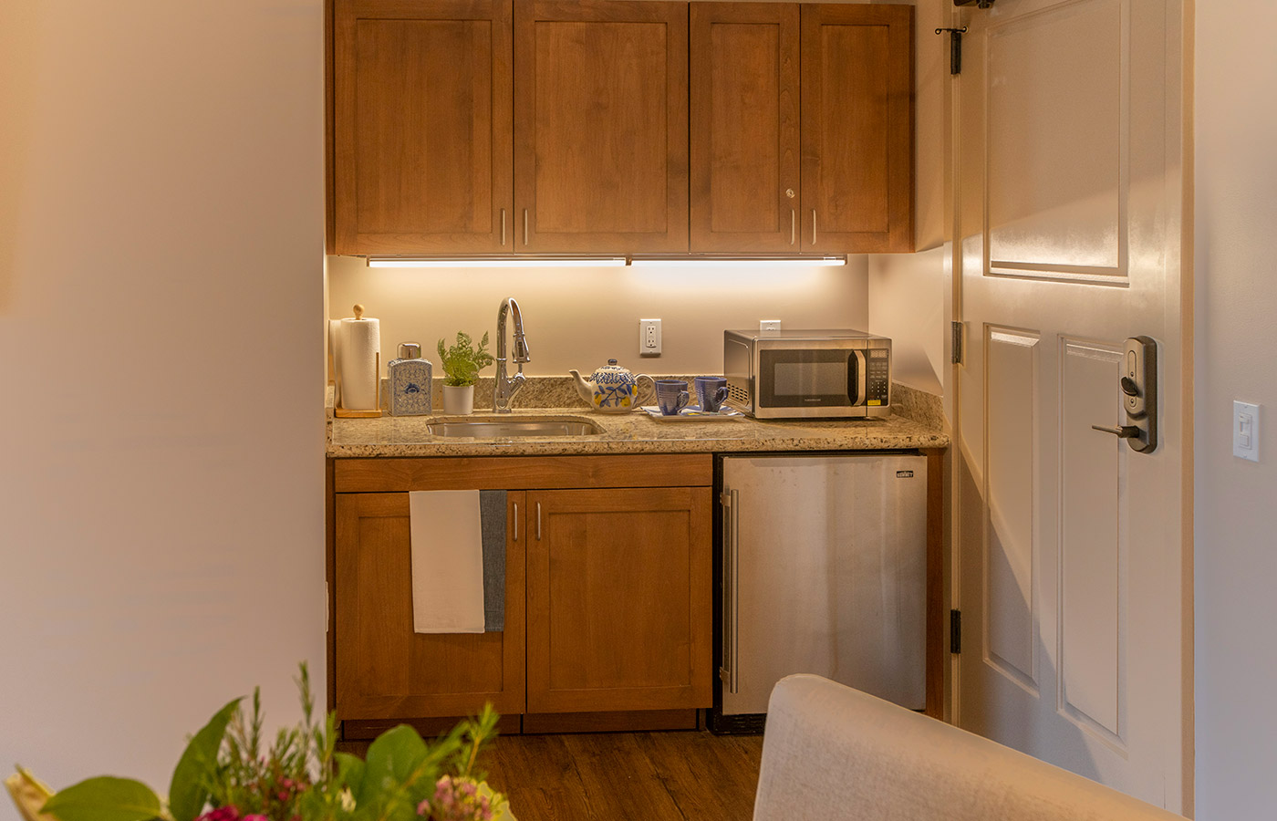 Kitchen with sink, refrigerator, and seating area.
