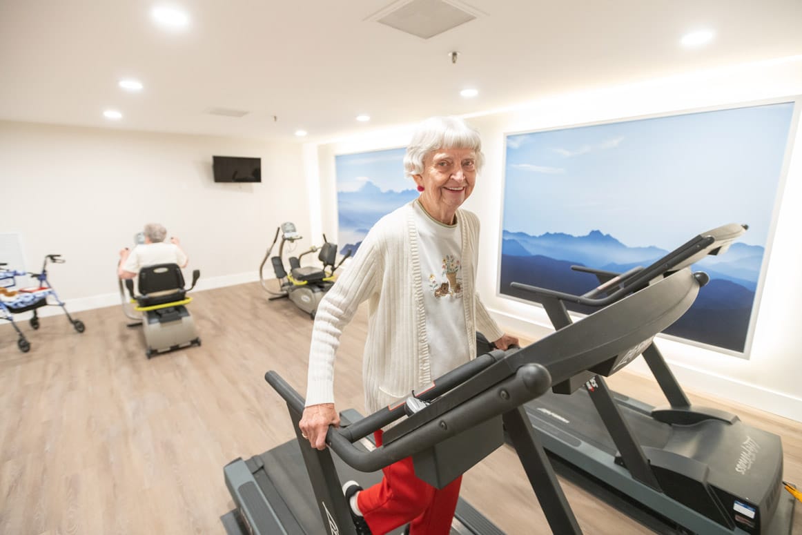 A resident is using a fitness machine.