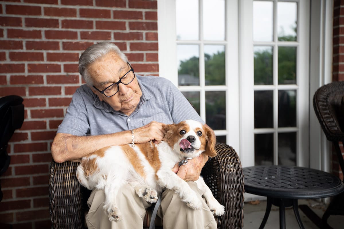 A resident is holding their dog.