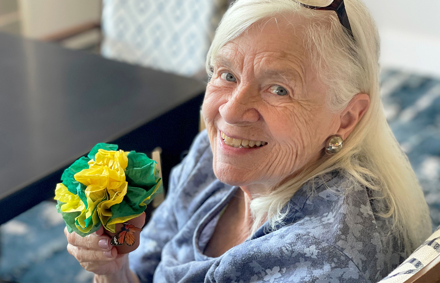 A resident is holding flowers.