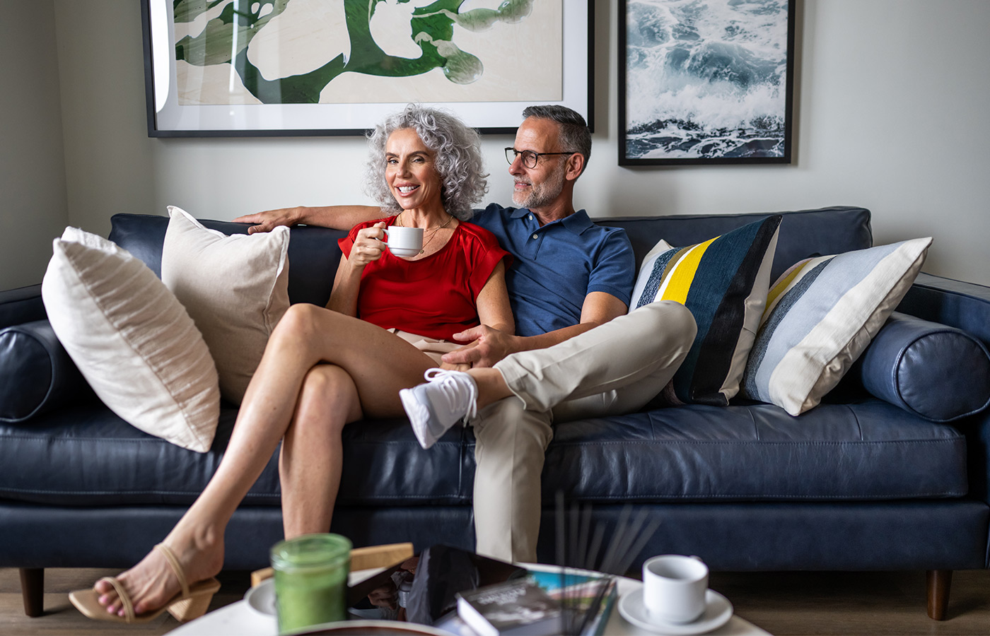 Two people sitting on the couch at home.