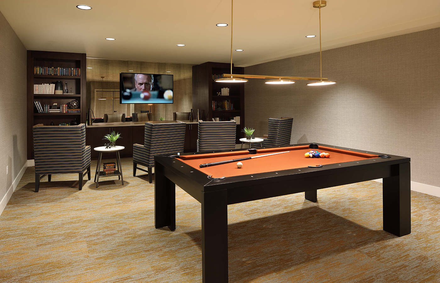 An activity room with a pool table.