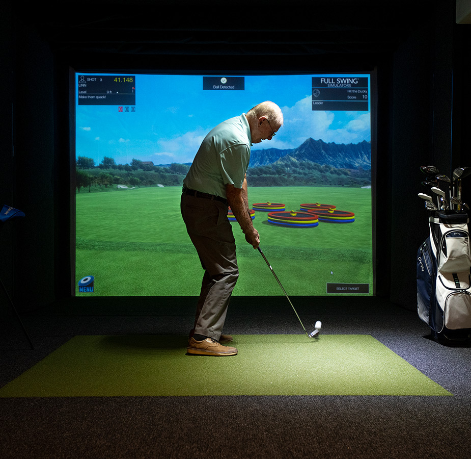 A person playing virtual golf.
