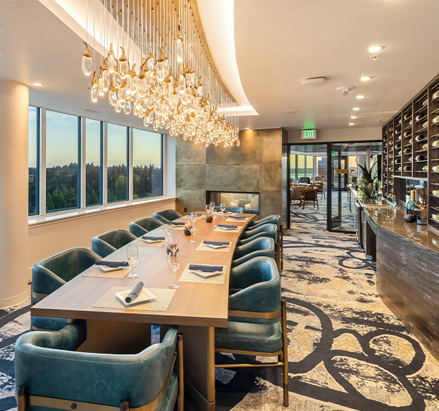 Private dining with a wall of wine bottles.