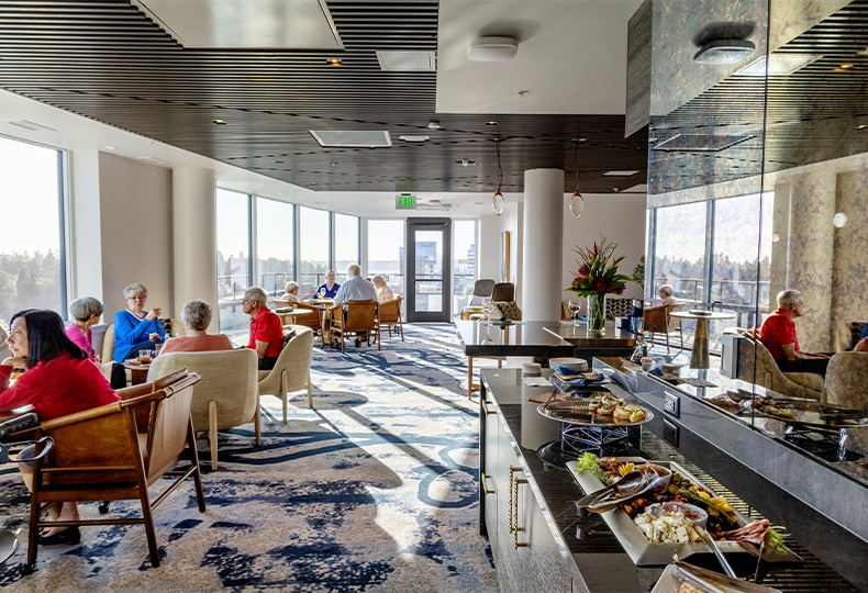 People in the lounge having food and drinks.