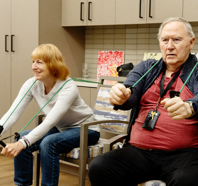 People in a seated workout class.